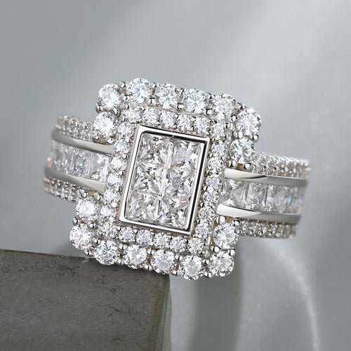 Silver rectangular multi-princess double-halo ring angled close-up