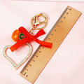 Jeweled Heart Frame Persimmon Keychain with Red Bow and Gold Tone Hardware view 4