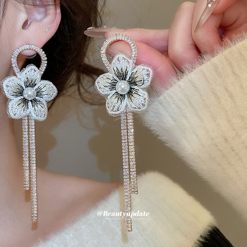 Product image 1 showing pale blue fabric flowers with pearl centers and slim chain fringe