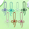 Butterfly Charm Keychains Featuring Magenta Bow Across 17 Pictured Variations view 1