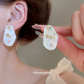 White Oval Floral Inlay Stud Earrings in Gold Tone view 1