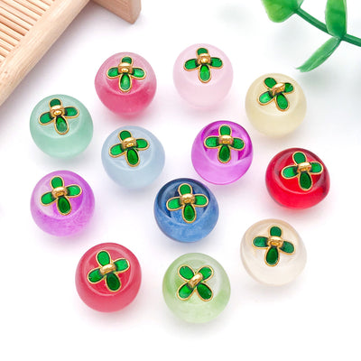 Styled close-up of translucent apple glass charm showing colors and surface details