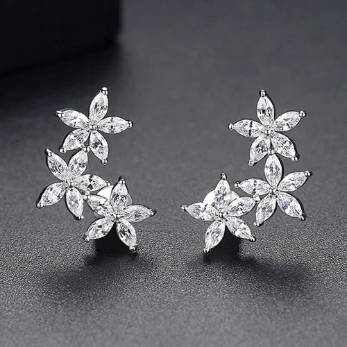 Pair of marquise crystal flower cluster studs on dark surface