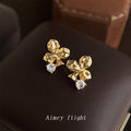 Gold Tone Sculpted Three Petal Flower And Clear Stone Stud Earrings view 1